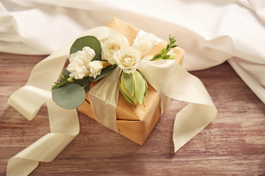 Handcrafted gift box with flowers on wooden table