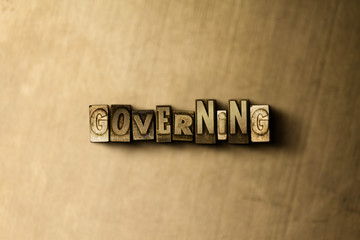 Naklejka premium GOVERNING - close-up of grungy vintage typeset word on metal backdrop. Royalty free stock illustration. Can be used for online banner ads and direct mail.