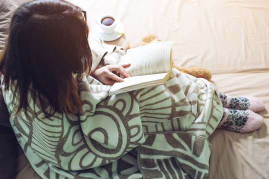Woman Wrapped In A Warm Blanket Reading Book
