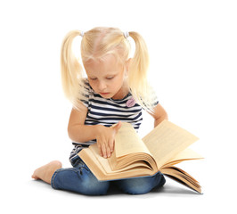 Cute small girl reading book on white background