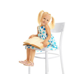 Cute small girl reading book on white background