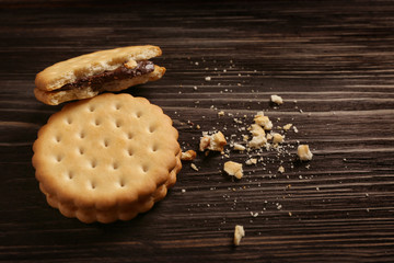 Obraz na płótnie Canvas Tasty cookies with crumbs on wooden background