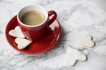 cup of espresso and cookies in the form of hearts on Valentine's Day