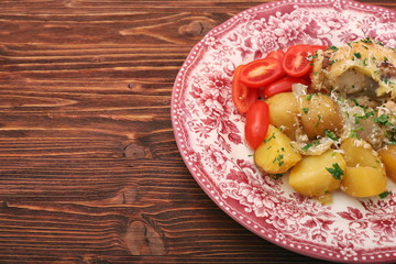 oven baked chicken fillet with potatoes and rosemary on woden table
