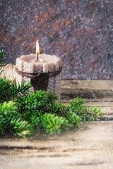Fototapeta na wymiar knitted candle pine and snow on wooden background