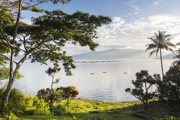 Lake Toba (Danau Toba) and fishing boats at sunrise, North Sumatra, Indonesia