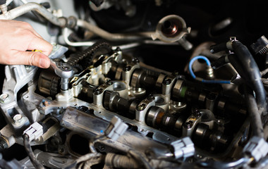 Fototapeta na wymiar Hand with wrench. Mechanic. Auto repair shop.