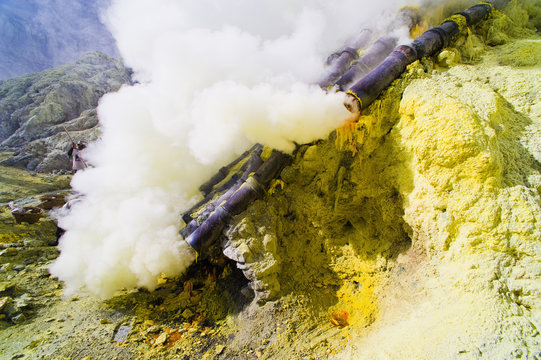 Toxic sulphur fumes escaping from the ceramic pipes at Kawah Ijen, Java, Indonesia