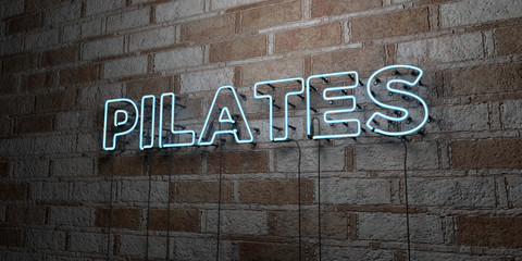 PILATES - Glowing Neon Sign on stonework wall - 3D rendered royalty free stock illustration.  Can be used for online banner ads and direct mailers..