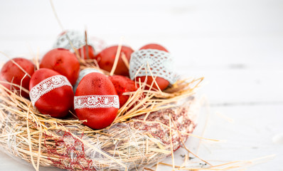 Red Easter eggs in a nest of hay
