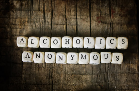 Background concept wooden cubes with letters alcoholics snonymous