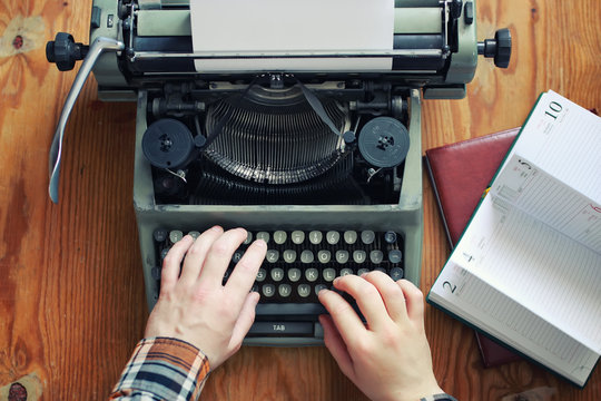 typewriter retro hand on wooden table