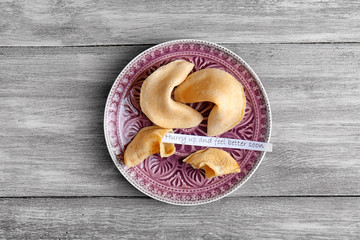 Plate with fortune cookies  on wooden background