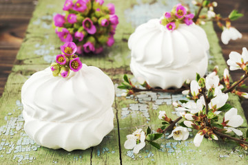  Delicate white marshmallows decorated with pink flowers on the