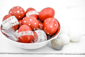 Red Easter eggs on a white plate