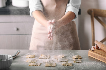 Woman making ravioli on table