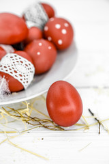 Red Easter eggs on a white plate