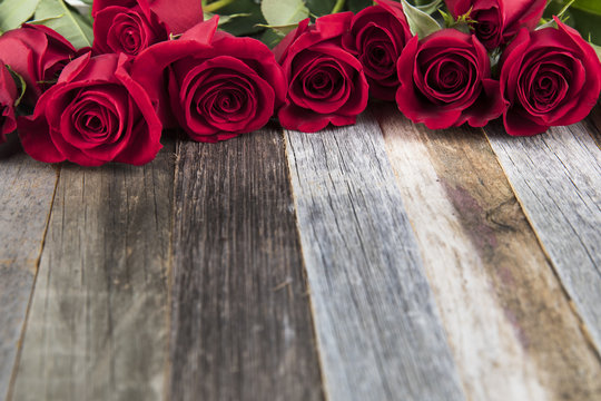Red Roses on Wooden Surface