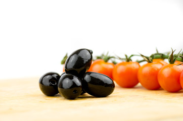 Fresh Olives And Cherry Tomatoes On Wooden Table With White Background Close Up