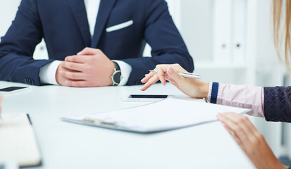 Girl using a mobile phone during a business meeting