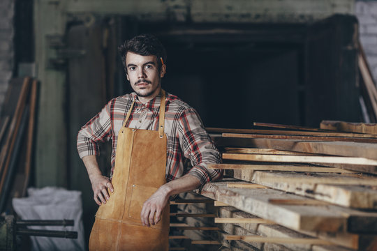 Portrait of carpenter standing in workshop