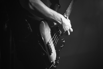 Closeup photo of bass guitar player - obrazy, fototapety, plakaty