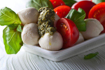  mozzarella with tomato , basil  and pesto sauce