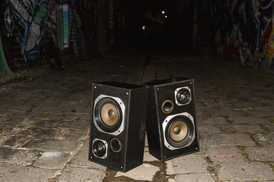 Abandoned speakers on street at night