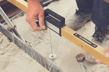 Construction worker leveling concrete pavement.