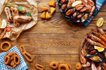 Seafood platter top view, flat lay on wooden table background © Prostock-studio