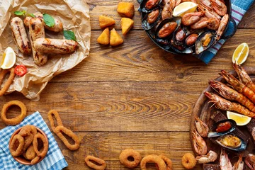 Fotobehang Assortiment Seafood platter top view, flat lay on wooden table background  © Prostock-studio