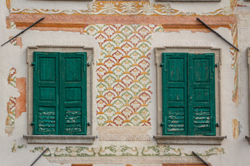 Painted vintage decoration of one of the facades in Udine, Italy