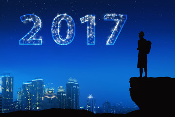 Silhouette asian young man with bright star on a 2017