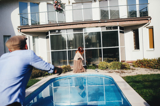 young and beautiful woman standing near swimming pool