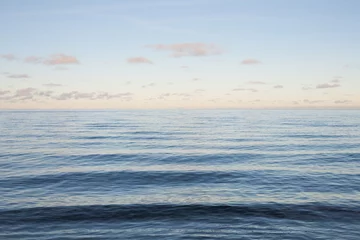 Crédence de cuisine en verre imprimé Côte Abstract tranquil blue sea, calm waves and pastel sunset background