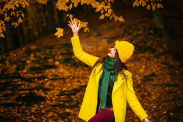 Fototapeta premium beautiful young woman walking outdoors in autumn