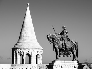 Mounted statue of Saint Stephen I, aka Szent Istvan kiraly - the first king of Hungary at typical white rounded tower of Fisherman's Bastion in Buda Castle in Budapest, Hungary, Europe. Sunny day shot