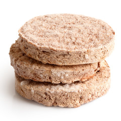 Stack of three frozen hamburger patties isolated on white.