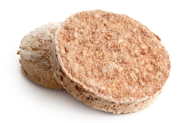 Two frozen hamburger patties isolated on white.