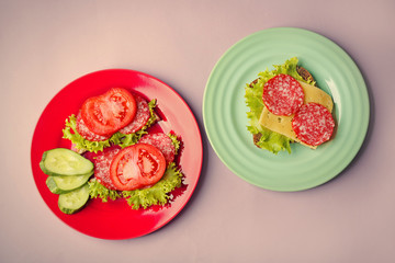 Plates with tasty food on wooden background, top view