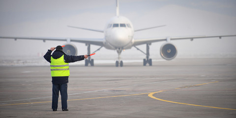 airport worker signaling