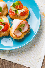 Bruschetta with tomato, cheese and bacon