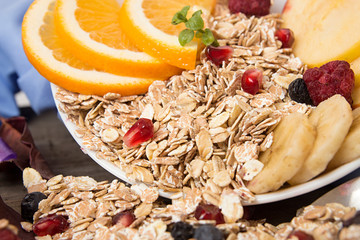 Healthy breakfast. Muesli with orange fruit, apple, pomegranate,