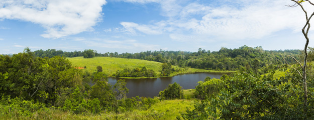 Panorama of Khoa Yai National Park.Blue sky clouds over tops of green trees

