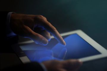 Businessman touching screen of modern tablet, closeup