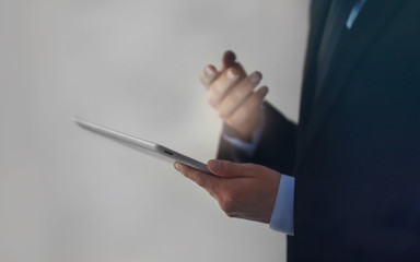 Businessman holding modern tablet, closeup