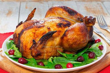 whole chicken roasted in oven on white plate