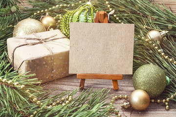 Miniature easel with blank card, gift box, pine branches and Chr