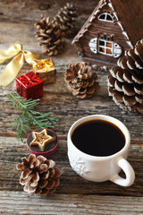 Obraz na płótnie Canvas Cup of coffee, pine cones and Christmas-tree decorations