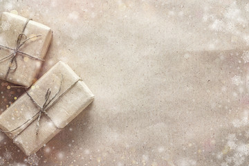 Gift boxes on brown wrapping paper. Christmas background. Space